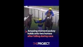Amazing moment jockey holds onto two horses after falling during race